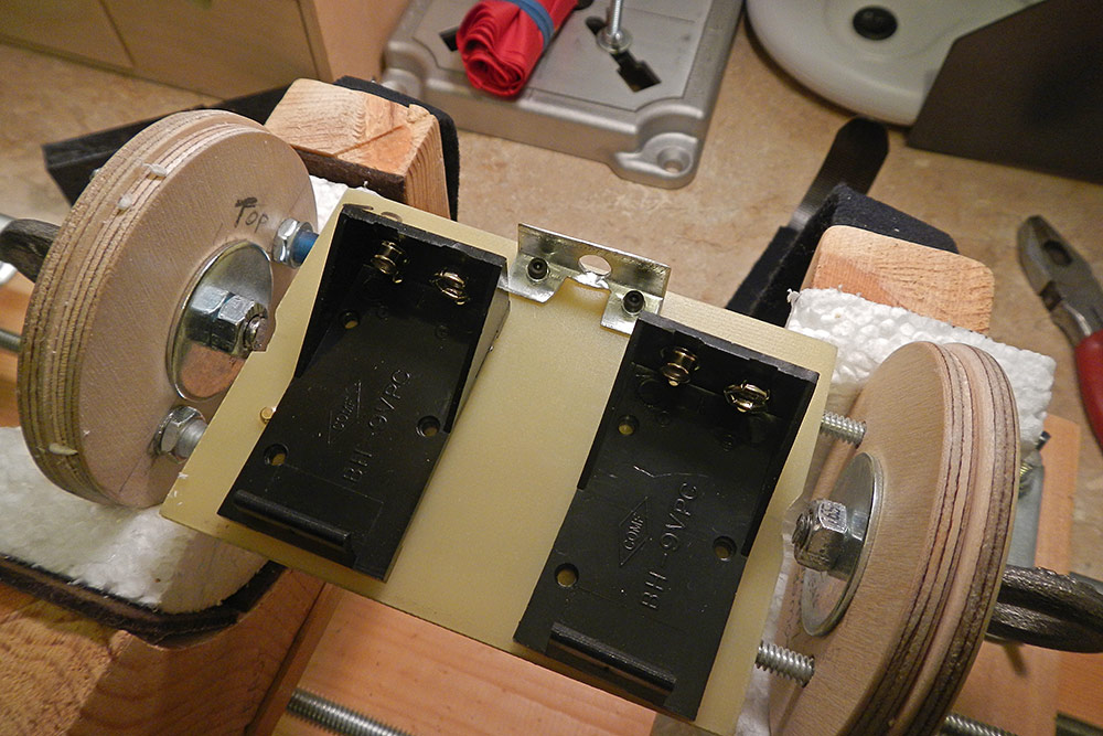 the reverse side of the G10 fiberglass sled, <br />showing the micro-switch shunt plate, <br />and two 9-volt battery holders...